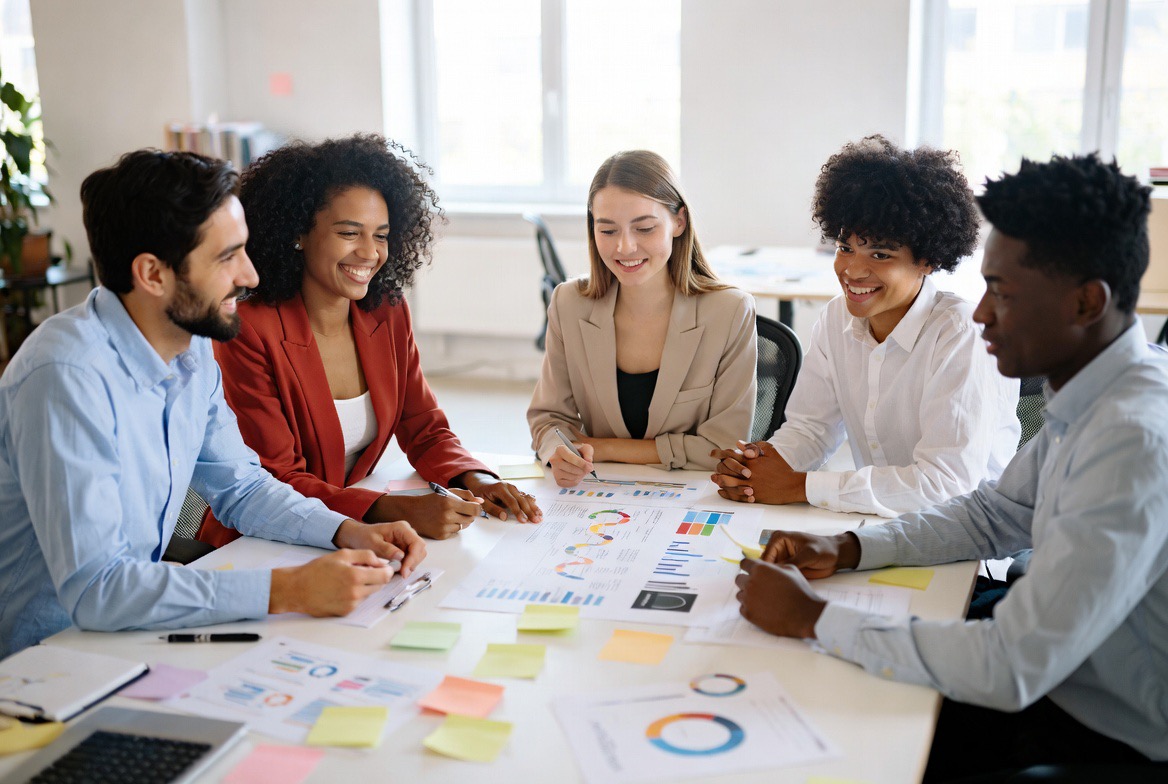 Diverse team of four professionals collaborating on content strategy in a modern office