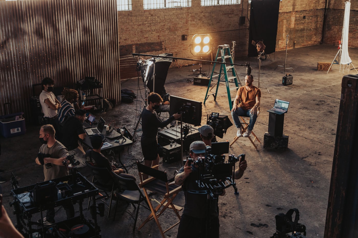 Film crew working on a movie set behind the camera.