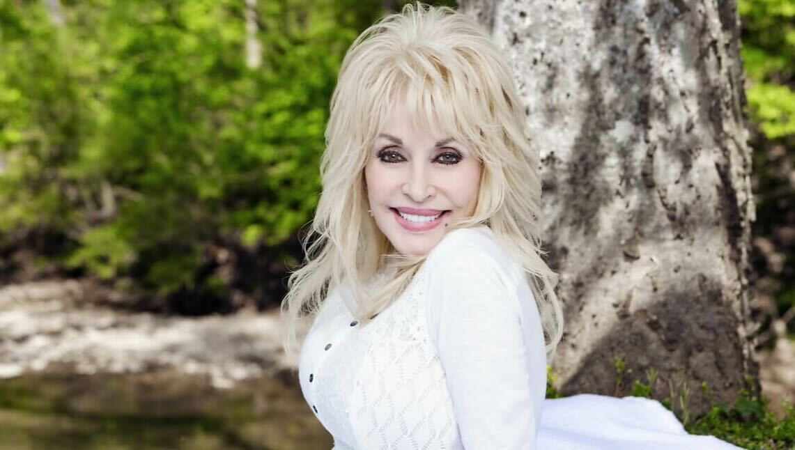 A picture of Dolly Parton on a beautiful white dress.